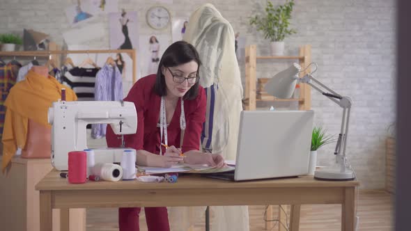 Young Fashion Designer Draws a Sketch alt