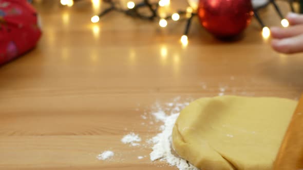 A woman rolls out the dough for Christmas baking. Baking for Christmas and New Year.