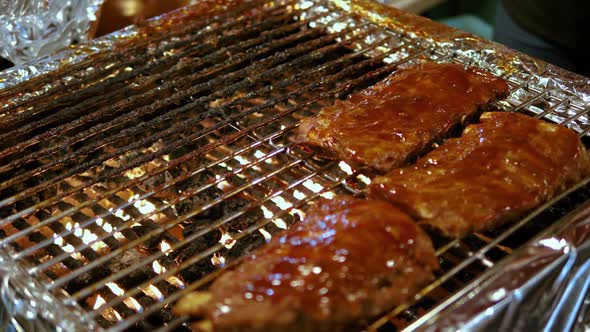 Close up Ribs with sauce on barbecue grill food night market, Bangkok alt