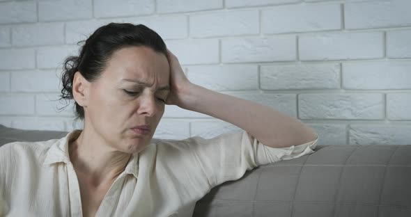 Woman feeling stress at home.  alt