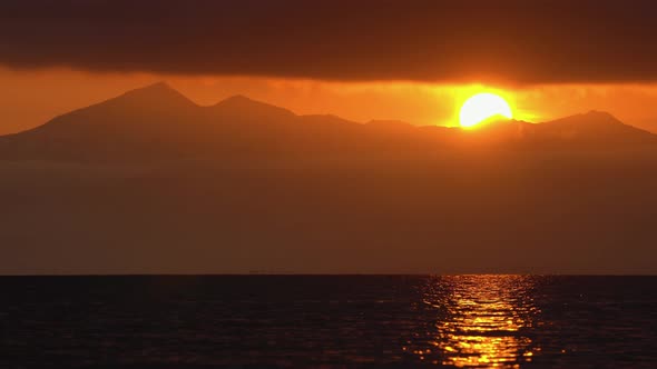 Stunning Seascape: Clouds Illuminated by Rays of Sun, Floating Across Sky