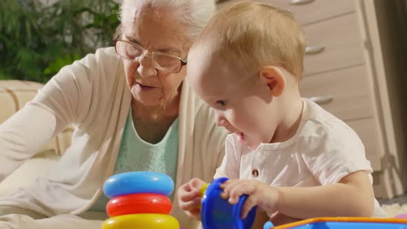 Little Kid and Grandmother Playing with Toys at Home