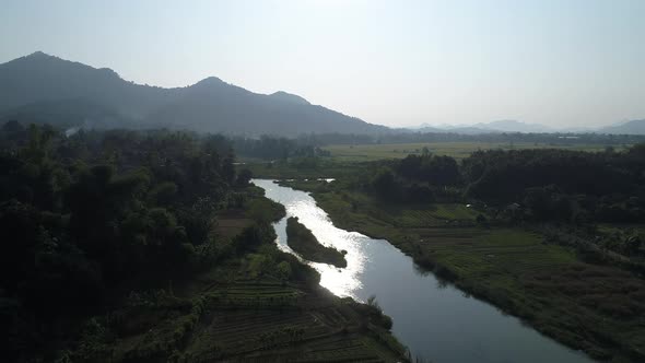 River near town of Vang Vieng in Laos seen from the sky alt