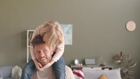 Portrait of Smiling Son on Fathers Shoulders at Home alt