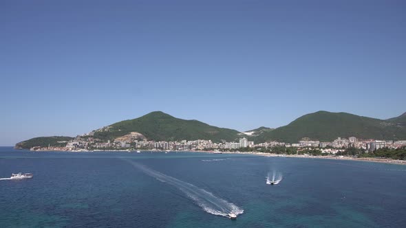 Pleasure Boats Sail on the Sea Off the Coast of Budva alt