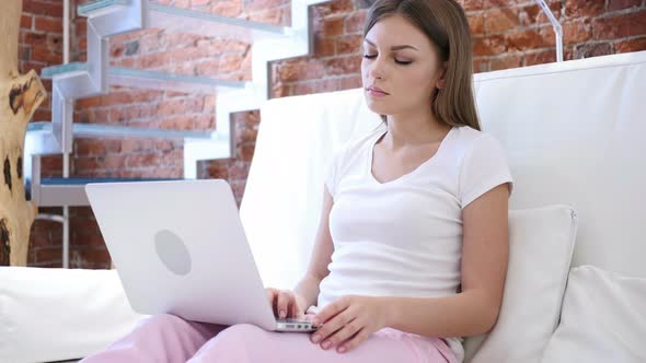 Tired Woman Relaxing Muscles, while Working on Laptop, Stairs alt