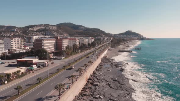 Resort city with beautiful coastline and car freeway. Coastal road. alt