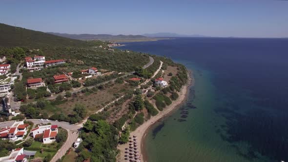 Flying Over Sea, Cottages and Resort on the Coast. Trikorfo Beach, Greece alt