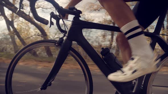 Cyclist Legs. Athlete Cyclist Fit Legs.Cyclist On Bike Cycling And Pedaling Sport Recreation alt