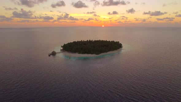 Aerial drone view of scenic tropical islands at sunset in the Maldives. alt
