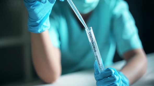 Doctor taking samples from coronavirus COVID-19 test tube