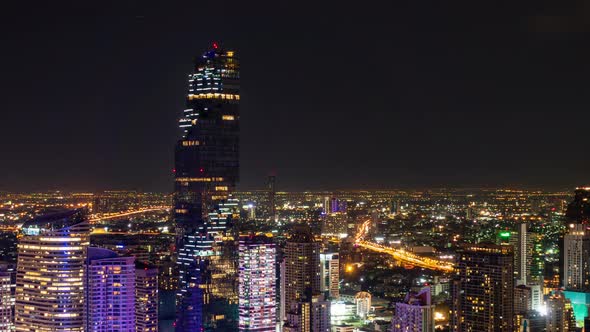 Bangkok business district city center above Sathon area rush hour traffic, at night – Time Lapse