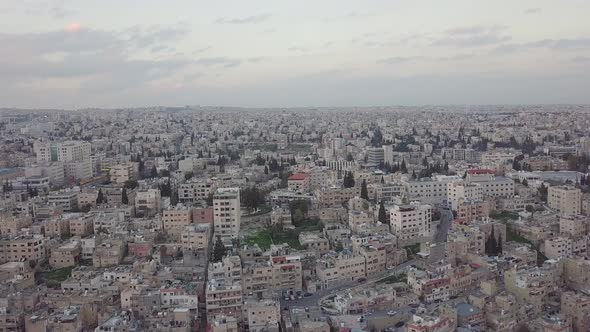 Serene early morning in Amman Jordan taken by a drone slowly descending and moving with a flock of p alt