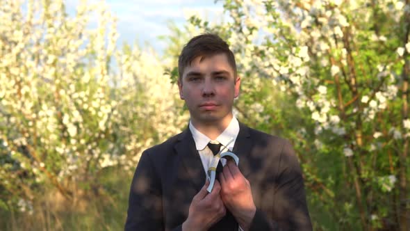 A Businessman Stands in the Garden and Sniffs Dollar Bills and Waves Them. It Became Hot Men in a alt