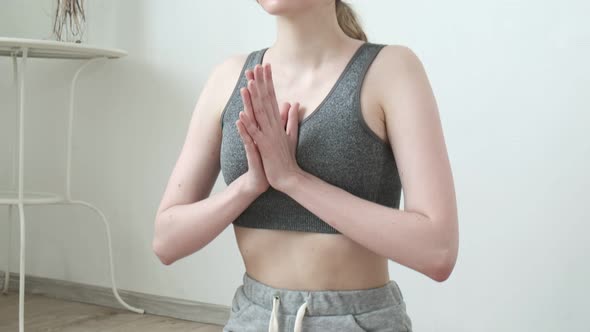 Pretty Girl in Sportswear Sitting in Lotus Pose Doing Breathing Yoga Exercises