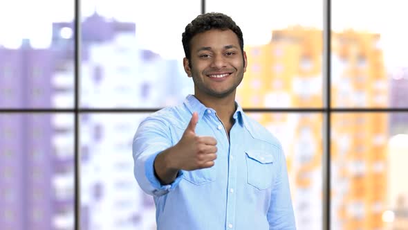 Portrait of a Happy Young Darkskinned Hindu Man Shows Thumb Up alt