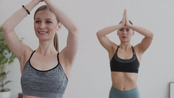 Two Female Yogi Exercising alt