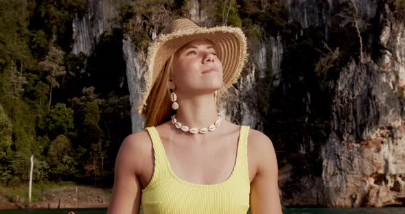 Portrait Shot of Beautiful Woman Enjoying the Warmth of the Sun on a Boat Ride alt