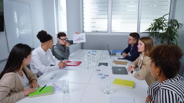 Business Team Discussing Growth Graph at Meeting alt