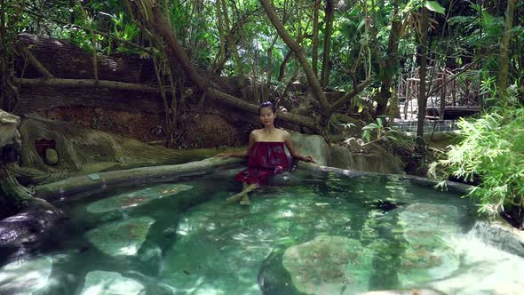 Cute Smiling Asian Girl Relaxing in a Hot Spring in Slow Motion Thailand