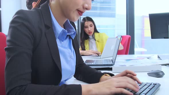 Asian employee officer attractive positive smile woman working on desktop alt