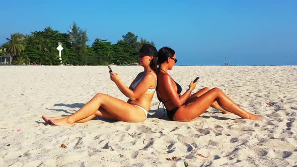 Female models posing on exotic bay beach holiday by aqua blue ocean and white sand background of Koh alt