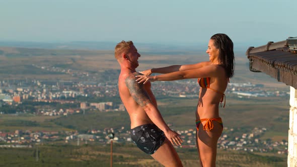 Woman pushing a man in the pool, Ultra Slow Motion alt