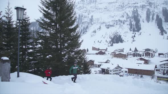 A man and woman couple having a playful snowball fight lifestyle in the snow at a ski resort alt