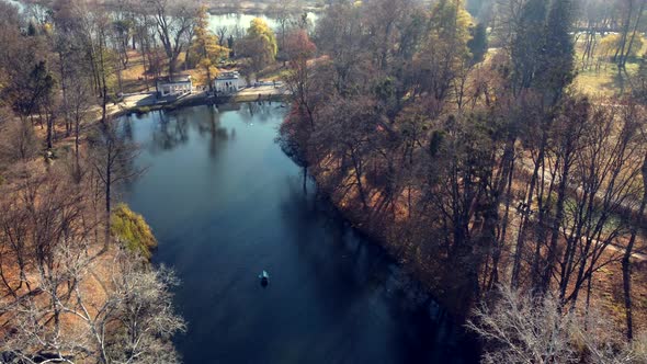 Arial Drone View Flight Over Lake in Park on Sunny Autumn Day alt