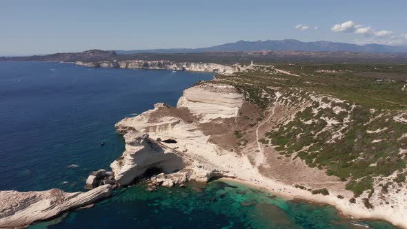 Aerial View of White Bluff Beach on Bay on the Coastline with Waves in the Blue Sea alt