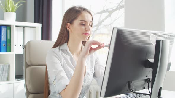 Young Woman Works at Home Office Using Computer. alt