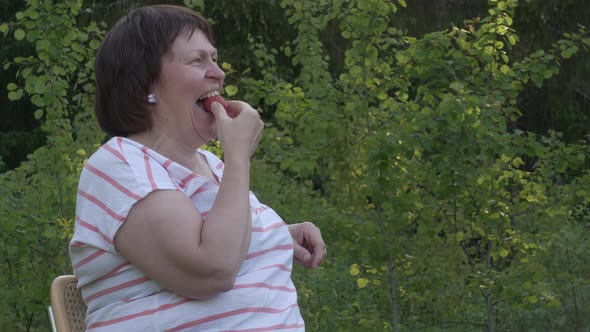Amazing Shot of a Caucasian Lady Laughing and Eating a Strawberry