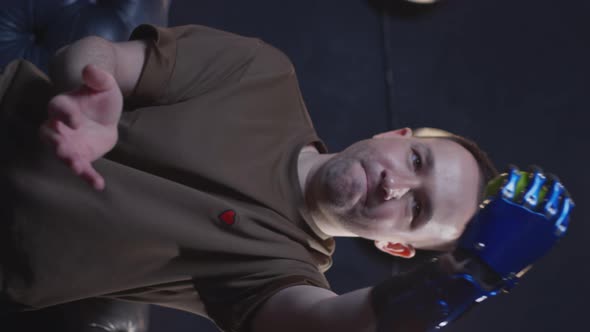 A Disabled Man with a Prosthetic Hand Juggles a Green Apple alt