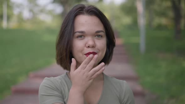 Closeup Coquette Caucasian Little Woman Gesturing Air Kiss Smiling Looking at Camera alt
