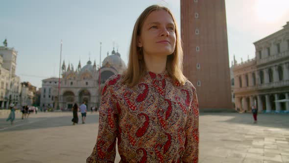 Confident Young Woman Walks in Venice Landmark on Piazza San Marco Italy