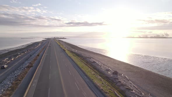 Vancouver scenic aerial sunset of main highway leading to Tsawwassen ferry terminal, cars driving fa alt