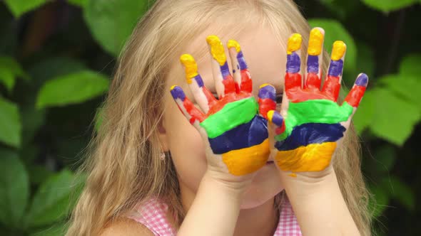 Child with paints in her arms