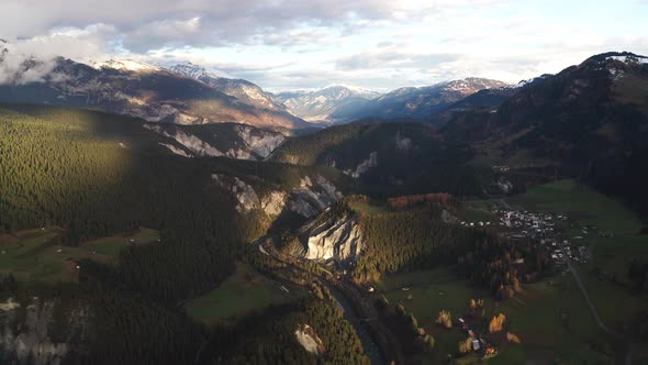 Drone flies above mountains in autumn with heavy brown colour contrast alt