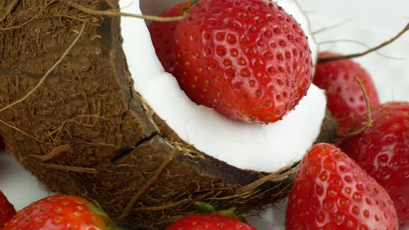 Rotation of juicy strawberries and coconut. Top view, 360 degree rotation, extreme close-up.