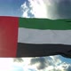 Flag of the United Arab Emirates Waving in the Air Cloudy Blue Sky in Background