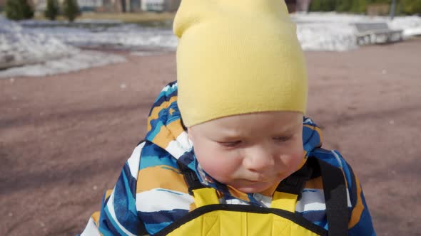 Child in Yellow Waterproof Rain Pants Bibs for Kids Learning to Walk on Footpath in Cold Season alt