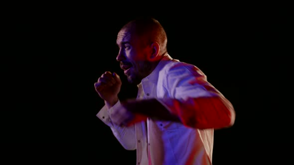 Confident Drunk Man is Punching Air and Fighting with Invisible Enemy in Night alt