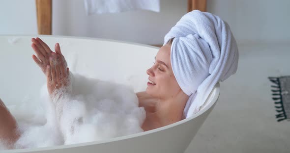 Closeup Beauty Portrait of Pretty Woman Chilling at Home Resting in Bathtub with Foam Washing Her alt