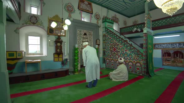 Muslim Male People Pray in a Robe and Turban at the Small Historic Wooden Masjid