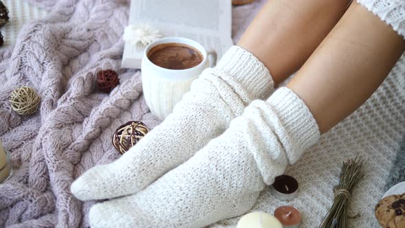Closeup Of Female Feet In Knitted Socks At Home, Cold Winter Season Concept alt