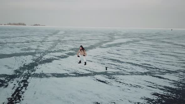 Stylish Young Woman Professional Dancer Dancing Energetic Jazz Funk or Hip Hop on Arctic Frozen Lake alt