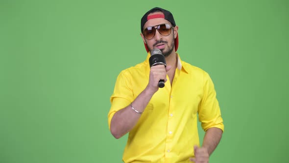 Young Bearded Indian Businessman Rapping with Microphone
