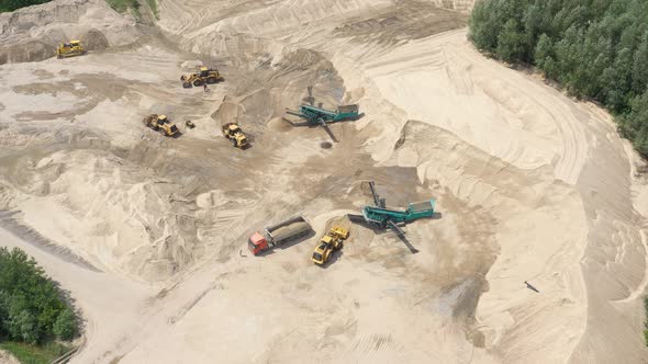 Drone flight over a bulldozer in the open cast mine. Sand mine. Aerial view alt