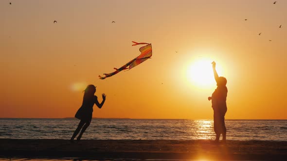 Grandmother Plays with Baby with Kite alt