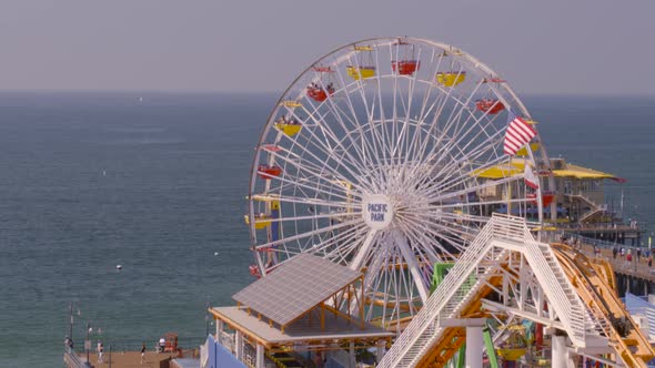 Aerial view of Ferris wheel at Pacific Park overlooking sea alt